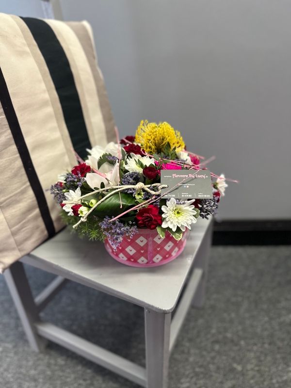 Stunning floral art in a black container,mums favorite!