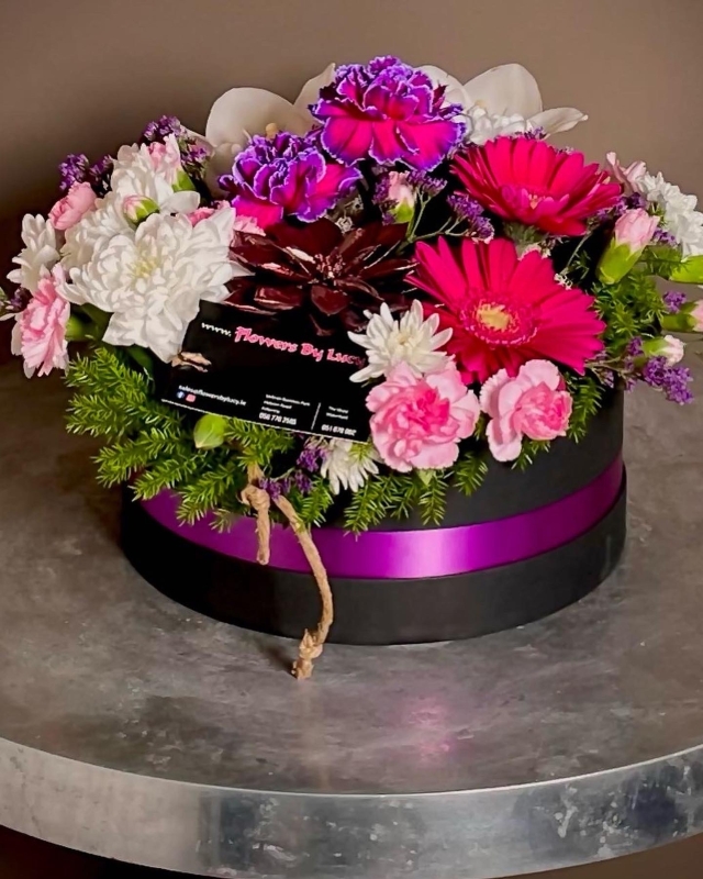 Stunning floral art in a black container,mums favorite!