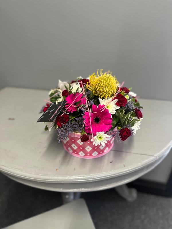 Stunning floral art in a black container,mums favorite!