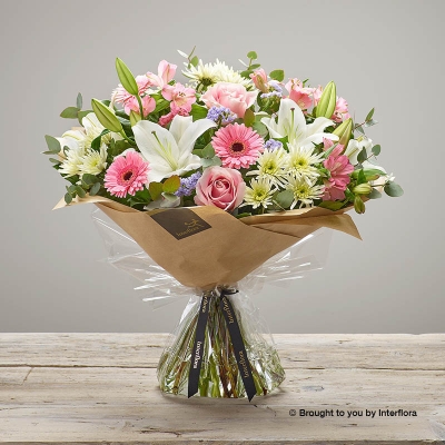 Pink Alstromeria White Lily Pale Pink rose White Chrysanthemum Lilac Statice Pink Germini & greenery in a Hand Tied Bouquet