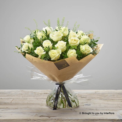 Twelve Ivory Roses & greenery in a hand tied bouquet