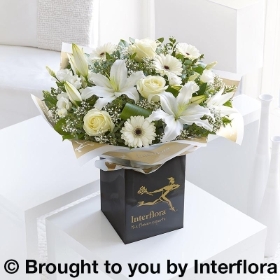 All white flowers oriental lily germini gypsophila lisianthus rose and greenery in a bouquet