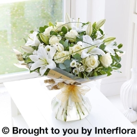All white Flowers. rose lily lisianthus and greenery in a bouquet