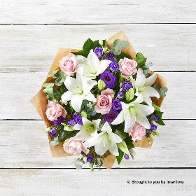 White Lily Purple Lisianthus Pink Rose & Greenery in a hand tied bouquet