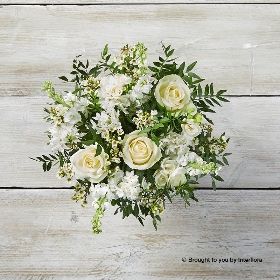 White Freesia White Narcissi White Stocks Ivory Rose White Waxflower & Greenery arranged in an Olive Green & Gold Vase
