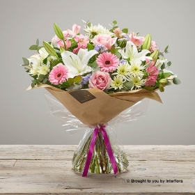 Pink Alstromeria White Lily Pale Pink rose White Chrysanthemum Lilac Statice Pink Germini & greenery in a Hand Tied Bouquet