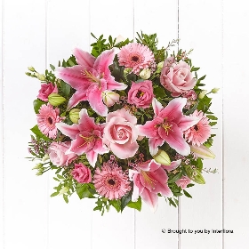 Pink Germini Pink Waxflower Pink Lily Pink Lisianthus Pink Rose & greenery in a hand tied bouquet