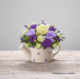 Purple Freesia Ivory Rose Purple Lisianthus White Spray Rose & Dried Lavender in lilac spot ceramic watering can