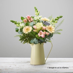 Pink alstro White antirrhinum Cream Germini Ivory rose & Greenery arranged in soft cream zinc jug