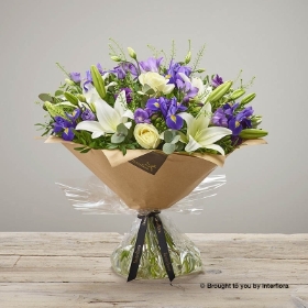 Purple Freesia Blue Iris White Lily Purple Lisianthus Ivory Rose & greenry in a Hand Tied bouquet