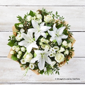 White spray Rose White Waxflower White Lily White Lisianthus Ivory Rose  & Greenery in a hand tied bouquet