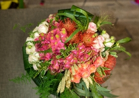 A selection of garden and tropical flowers in shades of pinks and oranges