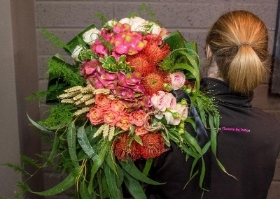 A selection of garden and tropical flowers in shades of pinks and oranges
